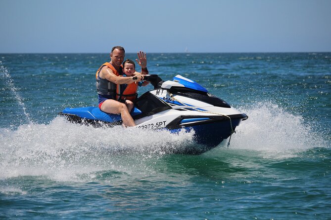Father and child riding a jetski on Hartbeespoort Dam