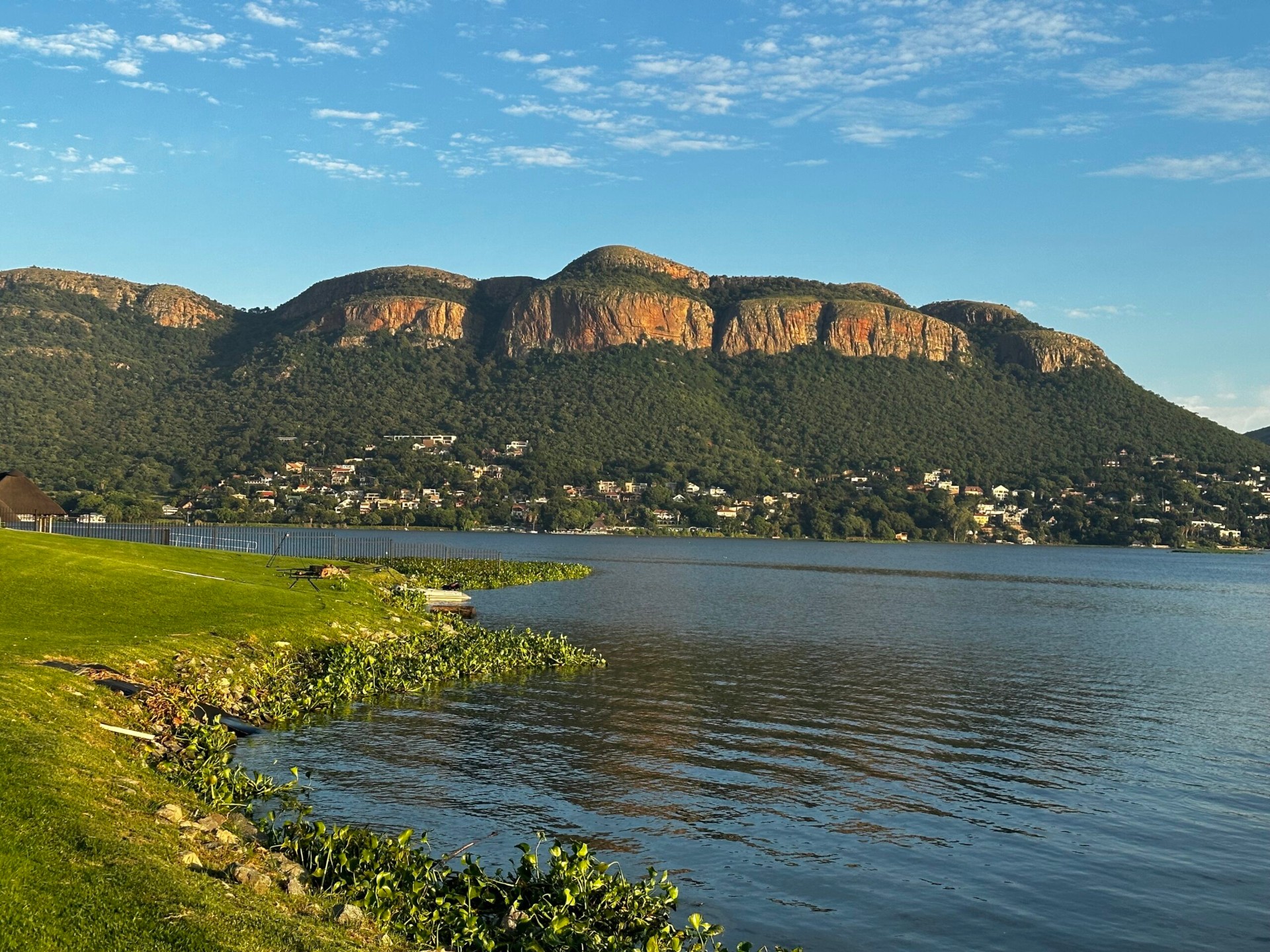 Scenic Hartbeespoort Dam shoreline with Magaliesberg mountains